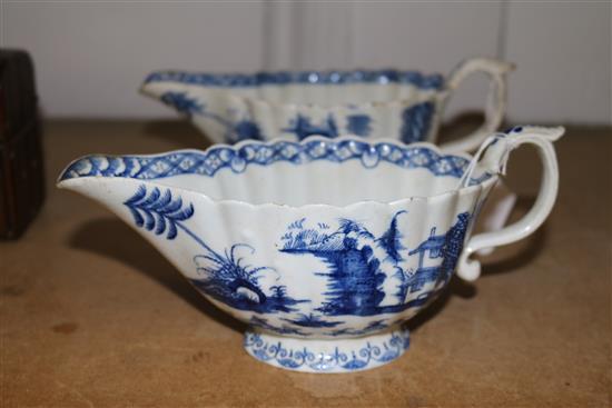 Two similar Bow Desirable Residence pattern blue and white fluted sauceboats, c.1765-70, length 21.5cm and 22cm